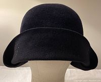Front view of navy wool cloche hat on mannequin, showing wide brim and velvet finish.