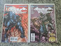 Two Batman The Dark Knight comic books, issues #1 and #2 from 2011, front covers showing Batman in dynamic poses with city and character backgrounds, both bagged and boarded.