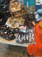 Photo showing shoes, backpacks, packaged apparel and accessories spread on a surface