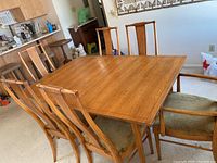 Full view of table set with six chairs in dining area