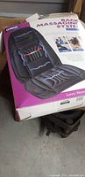 Photo of unopened Conair Family Fitness back massaging system in original box, showing front product image and partially visible branding.