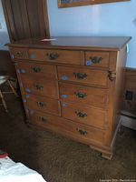Front view of the high dresser showing drawer arrangement and metal handles.