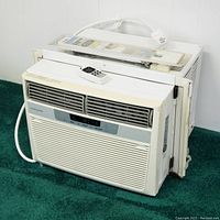 Frigidaire air conditioner side and back view showing remote control on top and window support kit behind unit