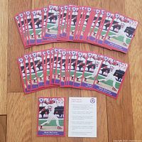 Top view showing 50 Mark McGwire vintage cards fanned out on wooden surface