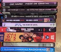 Stack of DVDs including Die Hard and other movie titles