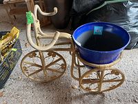 Overall view of bamboo bike planter with blue plastic pot on top