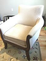 Front view of the chair showing wood frame, upholstery, cushion