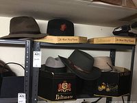 Shelf with multiple hats including Biltmore and Dobbs brand boxes