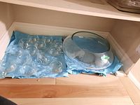 Top-down view of bowl and cups arranged on shelf