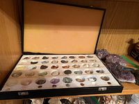 Top view photo of the open mineral sampler box showing mineral names and specimen cavities