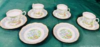 4 porcelain teacups and 6 matching plates displayed to show overall condition and matching design
