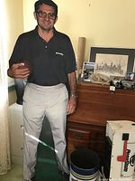 Photo showing Joe Paterno cardboard cutout holding football with memorabilia on wooden desk behind.