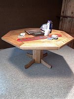 Wooden octagonal poker table with various poker-related items on top