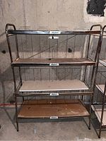 Front view of one metal shelving unit with four shelves labeled 'Wyler's' showing metal frame and wire back