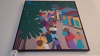 Front view of colorful street scene framed art print with crowd and houses