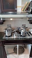 Stockpot and medium saucepan on stovetop
