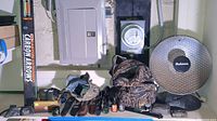 Wide view showing arrows box, heater, backpack, knives with sheaths, calls, scope, binoculars