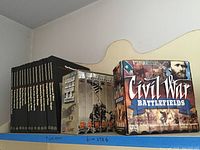 Photo showing fifteen-volume set of The Vietnam Experience books and Civil War Battlefields VHS box set on a shelf.