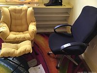 Black modern office chair and yellow upholstered chair with ottoman shown side by side, with instructions and tools on floor near yellow chair.