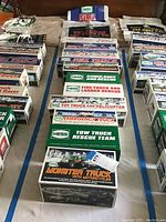 Overhead view of all Hess truck boxes and bags laid out on cloth background, showing full collection and packaging details.