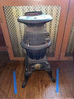 Full height view of entire cast iron stove in room