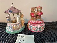 Photo showing two Bainbridge Bears musical boxes side by side, one a wishing well theme and one with two bears holding hearts saying 'Love' and 'For You'