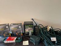 Lot photo showing Westinghouse digital timer, Yard Master power stake, two boxes of commercial grade icicle string lights, and three coiled extension cords