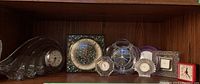 Group view of six tabletop clocks on shelf