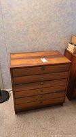 Front view of six-drawer wood dresser with drawers closed