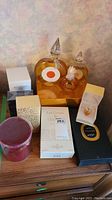Group of all fragrance items including two glass perfume bottles, boxed Guerlain Nahema, Guerlain Les Cœurs de Chamade, Nina Ricci L'Air du Temps miniature, Annick Goutal cylindrical box