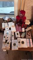 Overhead view of table with multiple fragrance boxes, sample packs and containers