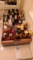 Cardboard box of approx. 21 assorted partially filled fragrance bottles