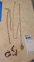 Lot contents including two necklaces, a pendant necklace, clip earrings and ring.
