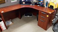 Photo of the full L-shaped office desk showing the surface, drawers on the right, and leg space under the desk.
