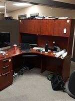 Full view of unfinished corner office desk with hutch showing scratches, office items removed from sale.