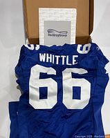 Blue New York Giants jersey with white number 66 and WHITTLE name on back, MeiGray Group documentation visible in box behind.