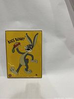 Front of original box showing Bugs Bunny holding a sandwich with bright yellow background