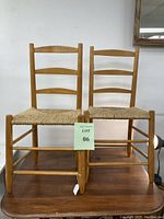 Pair of small-sized pine wood chairs with thatched seats, horizontal slat backs, in excellent condition, displayed side by side.
