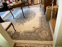 Full view of rug under table showing central medallion and border