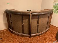 Full view of two-piece curved bar showing retro design, padded top edge, and ring accents on front panels.