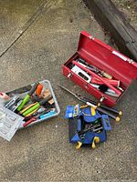 Overview of red metal toolbox, blue fabric toolbag, and plastic storage bin with assorted hand tools