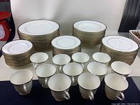 Overall view of all stacked plates, bowls and arranged tea cups on table