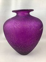 Front view of large purple art glass vase with gold speckle on white background.