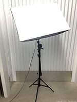 Front view of the photography softbox light mounted on the adjustable stand with power cable visible.