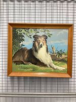 Front view of the framed Lassie dog painting showing the full artwork and wood frame.