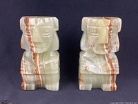 Front view of the two quartz stone bookends showing detailed carved design and natural striations.