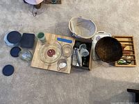 Top view of all kitchen items grouped, showing cake stand, butcher block, baskets, cups, and others