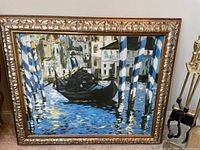 Impressionist style painting with blue boat and pillars with ornate gold frame