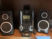 Teac micro hi-fi system CD-X70i with remote and two black speakers on wooden shelf