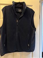Navy fleece zip-up vest from GAP with two zippered front pockets, size medium.